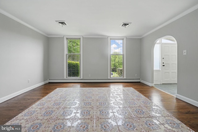 empty room featuring crown molding, visible vents, and arched walkways