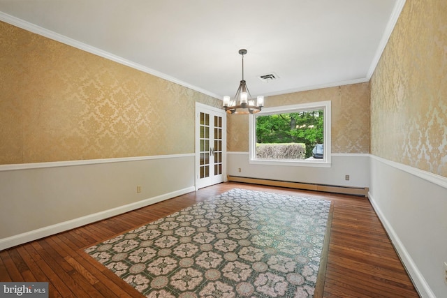 unfurnished dining area with a baseboard heating unit, ornamental molding, an inviting chandelier, visible vents, and hardwood / wood-style flooring