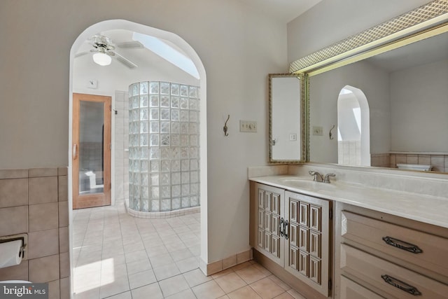 full bathroom with walk in shower, tile patterned floors, vanity, and ceiling fan