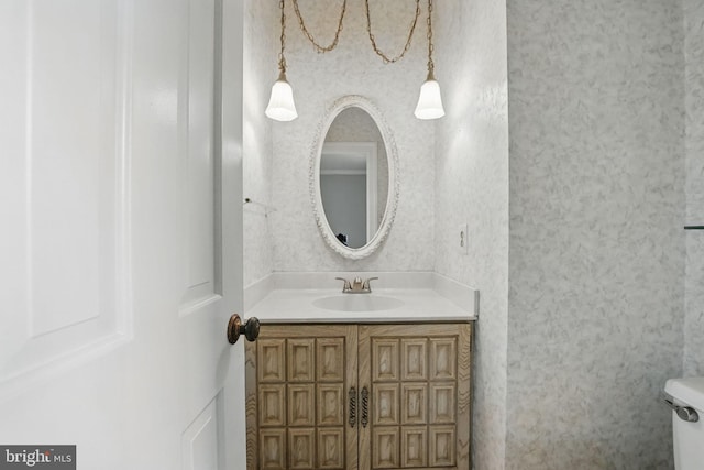 bathroom featuring toilet and vanity