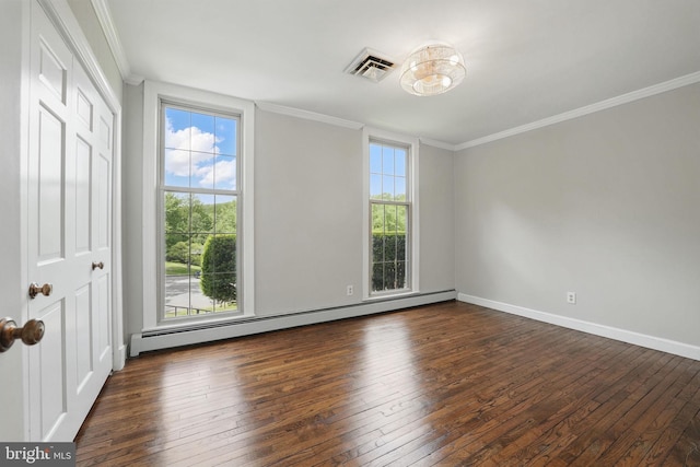 spare room featuring ornamental molding, hardwood / wood-style flooring, visible vents, and a baseboard heating unit