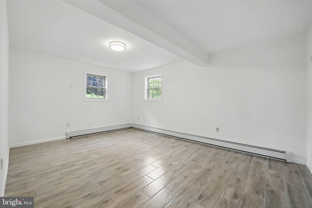 spare room featuring wood finished floors and baseboards