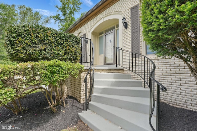 view of exterior entry with brick siding