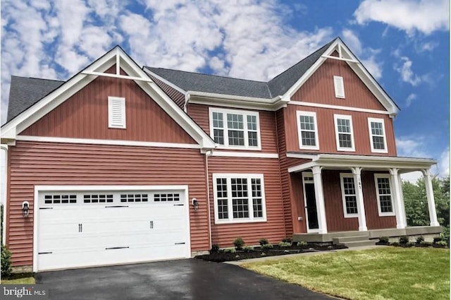 craftsman-style house with asphalt driveway, covered porch, a front yard, and a garage