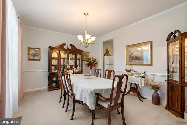 dining room with a chandelier, ornamental molding, light carpet, and baseboards