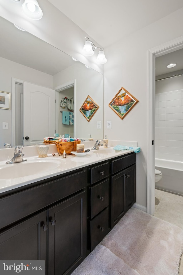 full bathroom featuring double vanity, tile patterned floors, and toilet
