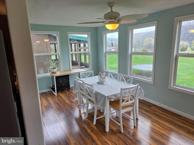 dining space with dark wood-style floors, baseboards, healthy amount of natural light, and ceiling fan