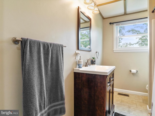 bathroom featuring vanity, baseboards, tile patterned floors, and toilet