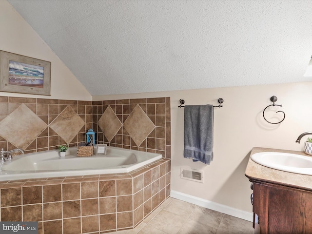 full bath with a textured ceiling, tile patterned flooring, baseboards, vanity, and lofted ceiling