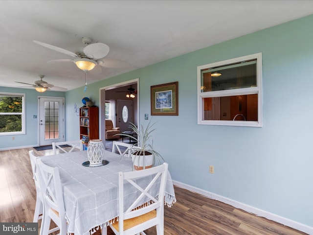 dining area with wood finished floors, baseboards, and ceiling fan