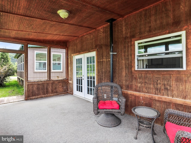 sunroom / solarium featuring french doors