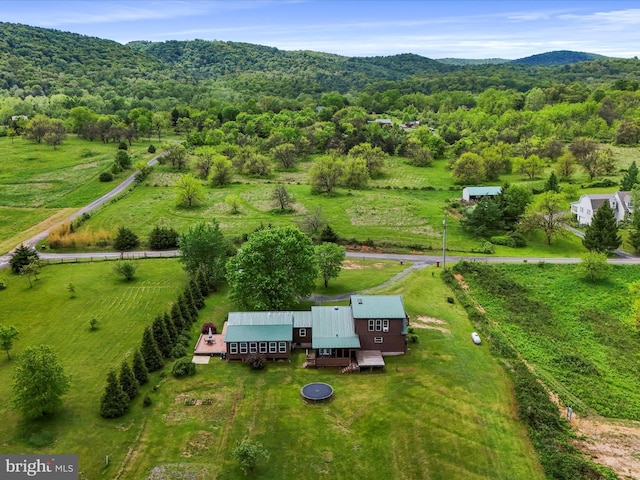 overview of rural landscape featuring a heavily wooded area and mountains