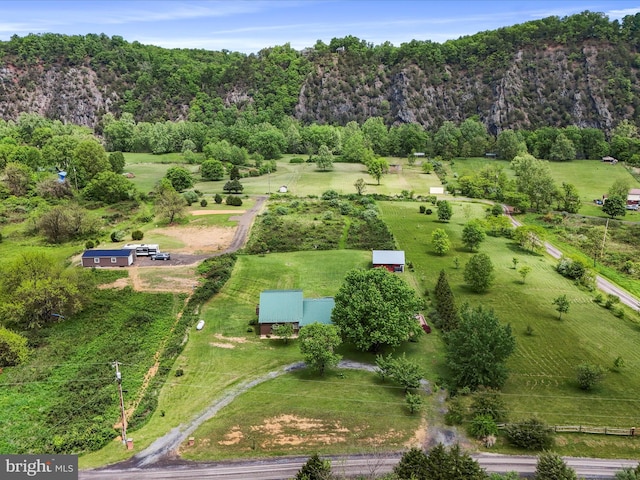 aerial view of property's location featuring a forest and rural landscape