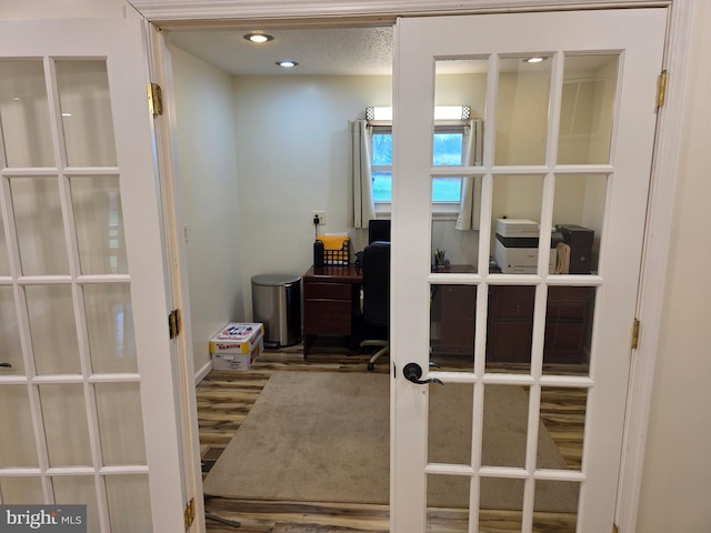 office with french doors, wood finished floors, and recessed lighting