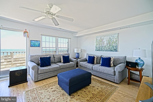 living area featuring wood finished floors and a ceiling fan