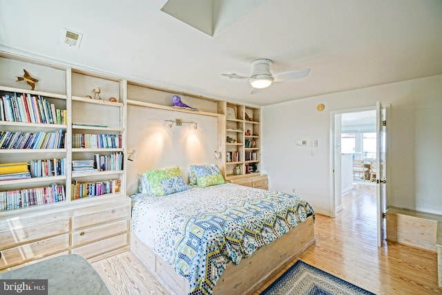 bedroom with wood finished floors, baseboards, and ceiling fan