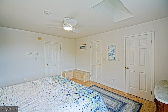 bedroom with light wood-style floors and a ceiling fan