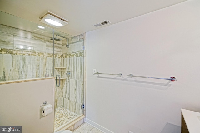bathroom featuring a stall shower, tile patterned flooring, vanity, and baseboards