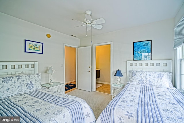 bedroom with ensuite bath and ceiling fan