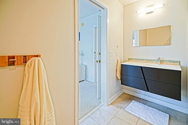 bathroom featuring marble finish flooring and vanity