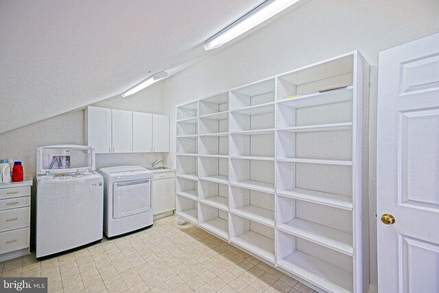 laundry room featuring washing machine and dryer and cabinet space