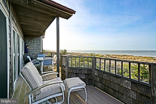 balcony featuring view of water and beach
