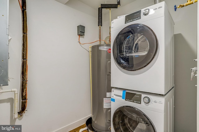 4902 D St SE, Washington, DC 20019 - laundry room with estacked washer and dryer, electric water heater, and baseboards
