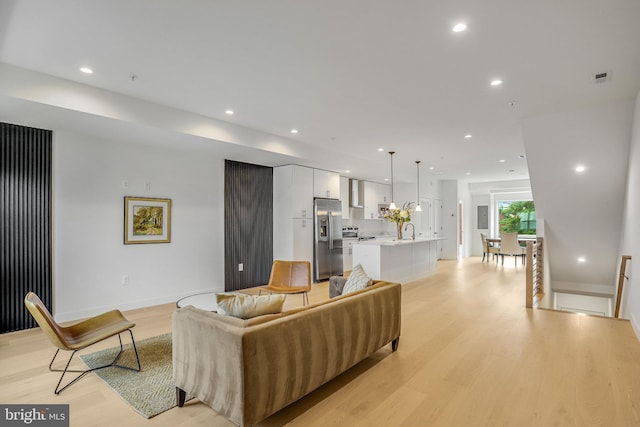 4902 D St SE, Washington, DC 20019 - living area featuring light wood finished floors, recessed lighting, and baseboards