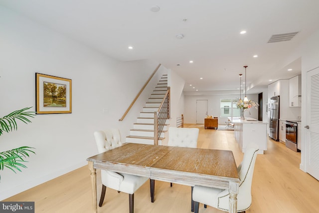 4902 D St SE, Washington, DC 20019 - dining room featuring stairway, light wood-type flooring, and recessed lighting