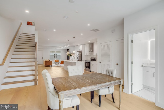 4902 D St SE, Washington, DC 20019 - dining room featuring light wood-style floors, stairs, and recessed lighting