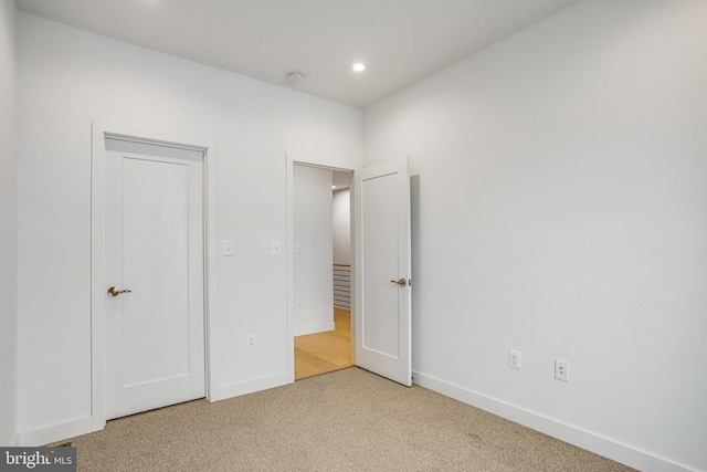 4902 D St SE, Washington, DC 20019 - unfurnished bedroom featuring light colored carpet, baseboards, and recessed lighting