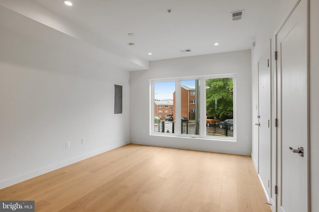 4902 D St SE, Washington, DC 20019 - empty room featuring light wood-style flooring, recessed lighting, baseboards, electric panel, and a pendent fire sprinkler