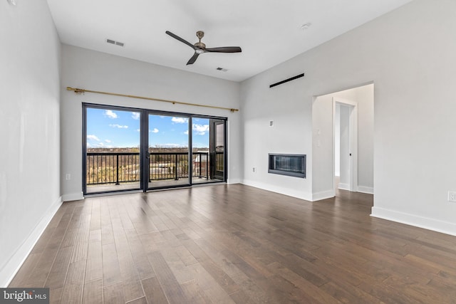 44691 Wellfleet Dr Unit 508, Ashburn, VA 20147 - unfurnished living room featuring dark wood-style floors, ceiling fan, a glass covered fireplace, and baseboards