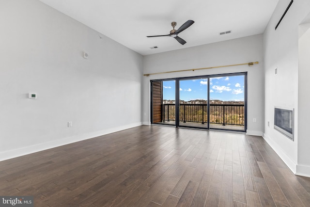 44691 Wellfleet Dr Unit 508, Ashburn, VA 20147 - unfurnished room with a ceiling fan, dark wood finished floors, baseboards, and a glass covered fireplace