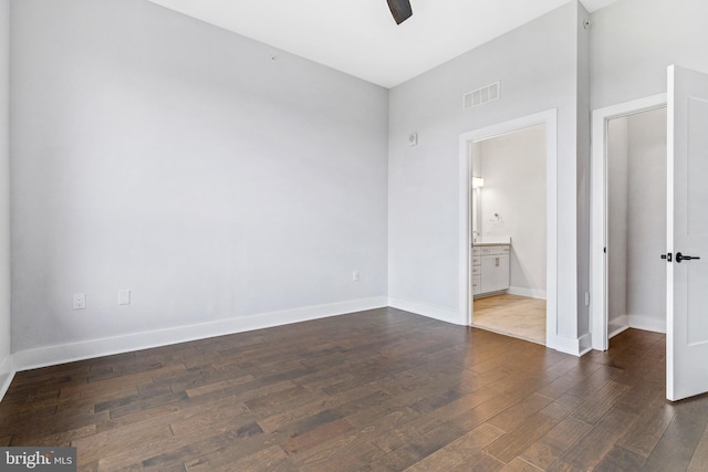 44691 Wellfleet Dr Unit 508, Ashburn, VA 20147 - unfurnished bedroom featuring dark wood finished floors, baseboards, ensuite bathroom, and ceiling fan