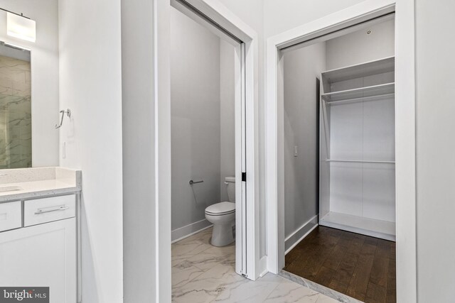 44691 Wellfleet Dr Unit 508, Ashburn, VA 20147 - bathroom featuring marble finish floors, toilet, vanity, and baseboards