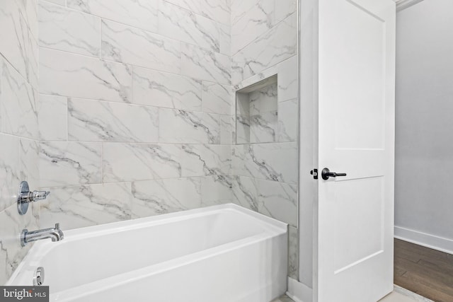 44691 Wellfleet Dr Unit 508, Ashburn, VA 20147 - bathroom with baseboards, bathtub / shower combination, and wood finished floors