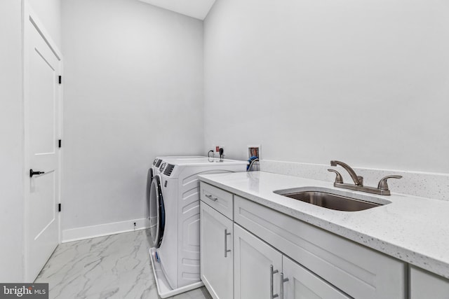 44691 Wellfleet Dr Unit 508, Ashburn, VA 20147 - laundry area featuring cabinet space, washer and clothes dryer, light marble finish flooring, and baseboards