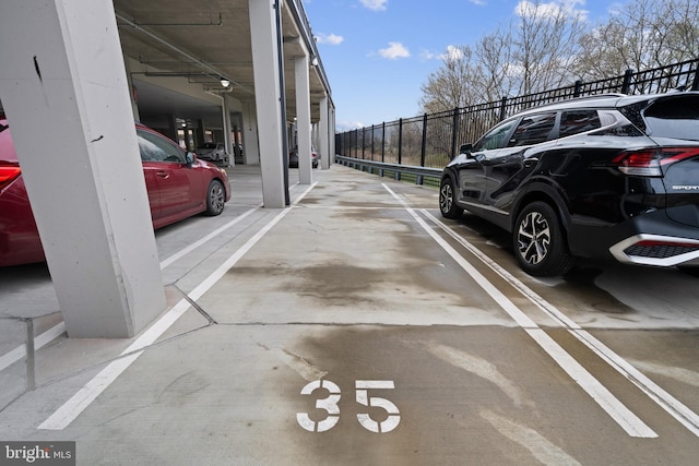 44691 Wellfleet Dr Unit 508, Ashburn, VA 20147 - view of parking featuring fence and a parking deck