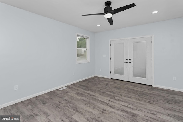 unfurnished room with french doors, a ceiling fan, wood finished floors, baseboards, and recessed lighting