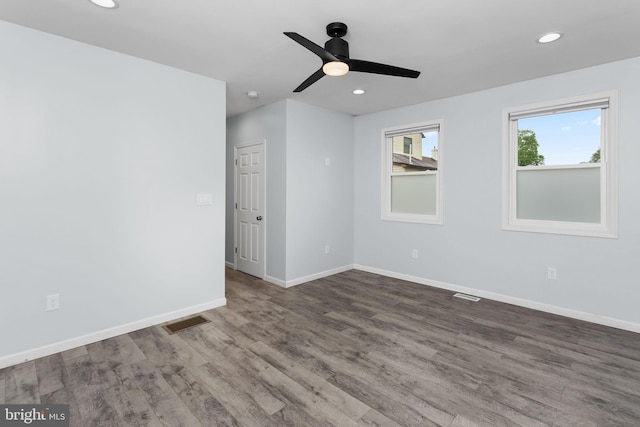 spare room with wood finished floors, a ceiling fan, baseboards, and recessed lighting