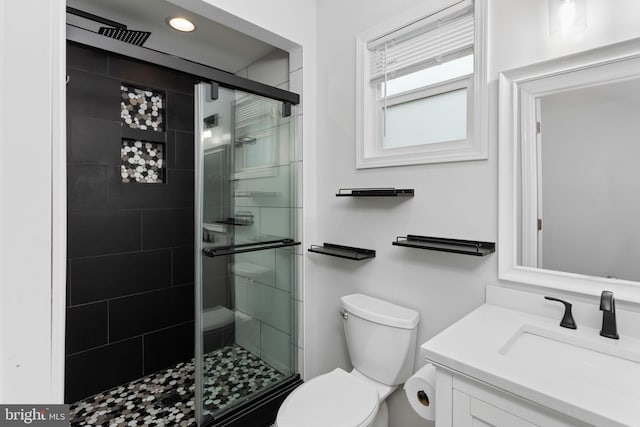 full bath featuring a stall shower, toilet, vanity, and recessed lighting