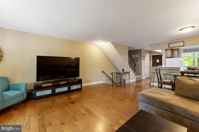 915 Burberry Ct, Sicklerville, NJ 08081 - living room featuring light wood-type flooring, stairs, and baseboards