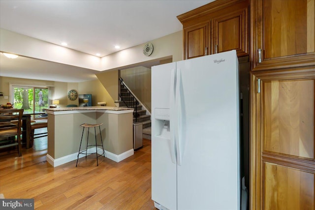915 Burberry Ct, Sicklerville, NJ 08081 - kitchen with white fridge with ice dispenser, light wood finished floors, brown cabinetry, and recessed lighting