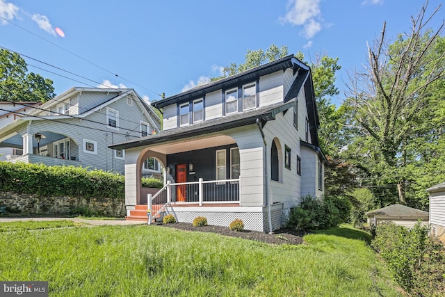 view of front of home with covered porch and a front lawn