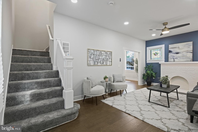 living room featuring stairway, dark wood finished floors, a ceiling fan, baseboards, and recessed lighting