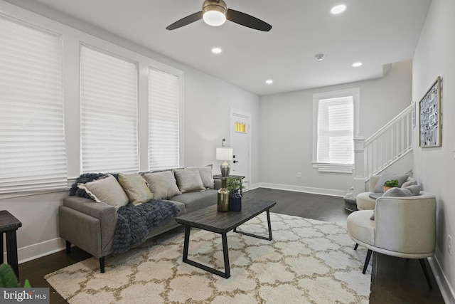living area featuring dark wood finished floors, a ceiling fan, recessed lighting, baseboards, and stairs