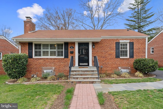 304 Moncure Dr, Alexandria, VA 22314 - view of front of home featuring a chimney, brick siding, and a front yard