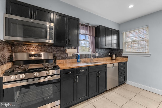 304 Moncure Dr, Alexandria, VA 22314 - kitchen featuring dark cabinetry, stainless steel appliances, tasteful backsplash, and a sink
