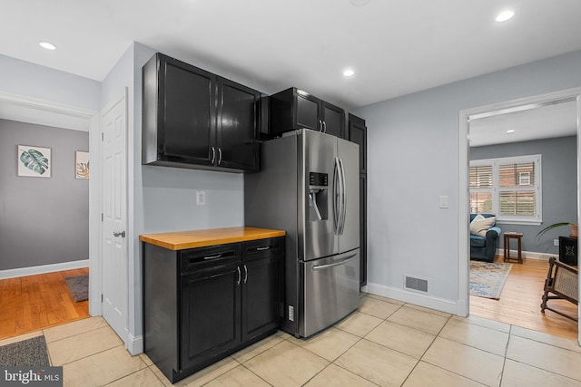 304 Moncure Dr, Alexandria, VA 22314 - kitchen featuring stainless steel fridge with ice dispenser, visible vents, dark cabinetry, and baseboards